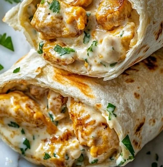 Cheesy garlic chicken wraps on a plate, perfect for quick weeknight dinners.