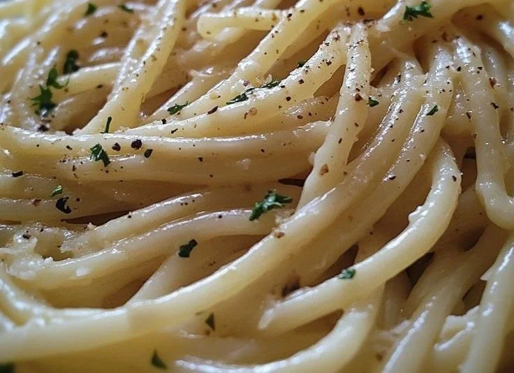 Plate of simple garlic butter noodles with parsley garnish