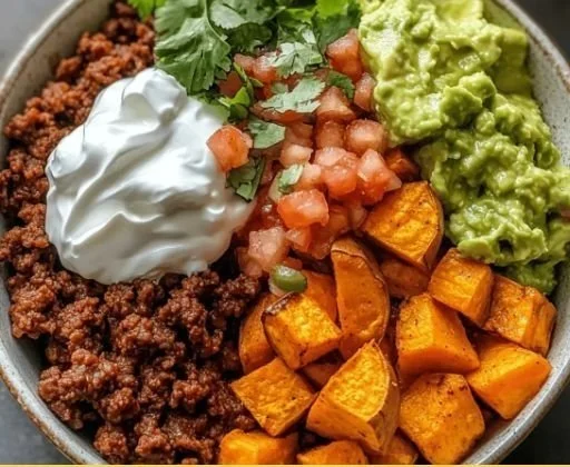 Delicious Sweet Potato Taco Bowl garnished with fresh toppings.